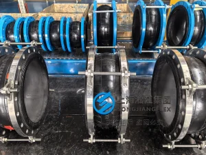 DN600 PN16 nuclear grade rubber expansion joint with EPDM bellows and S2205 duplex stainless steel flanges and limit rods for seawater cooling circuits.