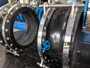 DN600 PN16 nuclear grade rubber expansion joint with EPDM bellows and S2205 duplex stainless steel flanges and limit rods for seawater cooling circuits.