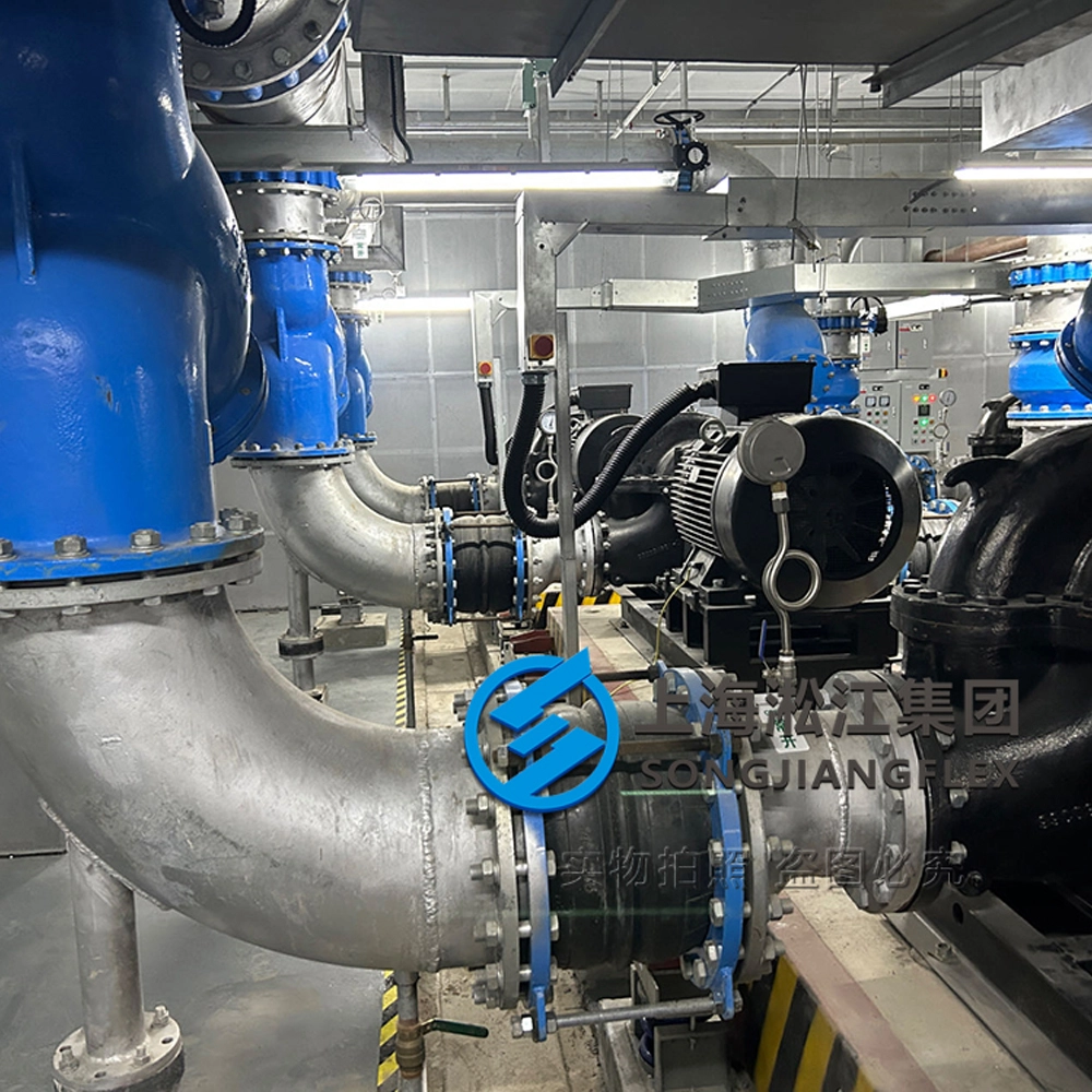 Multiple large diameter double sphere rubber compensators with control rods installed on a parallel centrifugal pump manifold inside the skyscraper ITC mechanical room
