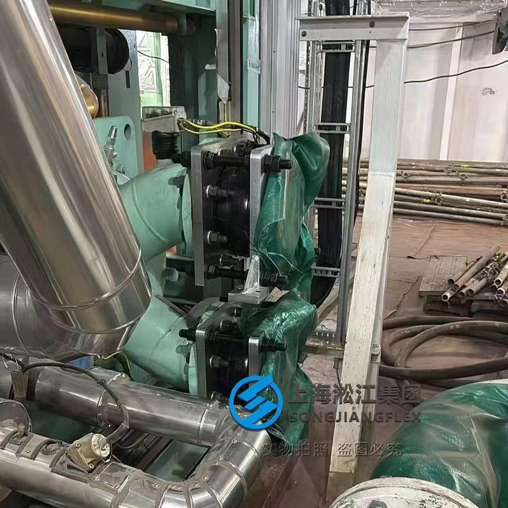 Rectangular flange rubber compensator with structural mounting feet and limit tie rods installed on a marine chiller unit pump interface