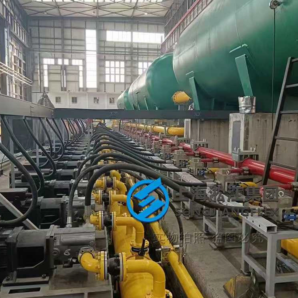 Premium rubber expansion joint installation safeguarding a central hydraulic power unit and high-volume oil lubrication circulation system from pump vibrations.