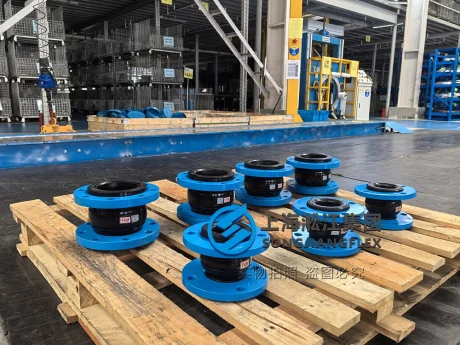 Premium FKM rubber expansion joints with blue steel flanges on a factory pallet, engineered for high-temperature chemical and hydraulic oil resilience.
