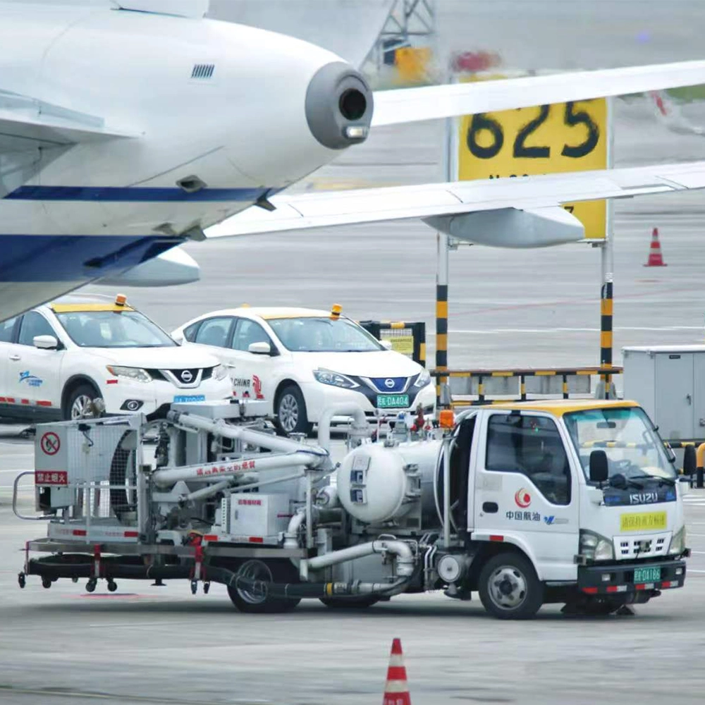An aviation hydrant dispenser truck servicing a commercial aircraft on the airport apron, displaying complex fuel pipelines requiring flexible rubber joints