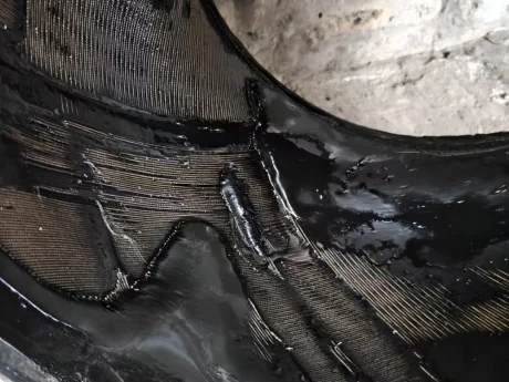 Inner liner wear and cord layer exposure of a standard rubber expansion joint caused by abrasive gypsum slurry friction