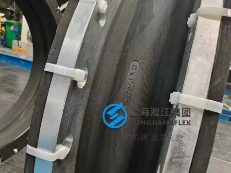 Detailed close-up view of a large-diameter rubber expansion joint compressing against an HDG carbon steel flange
